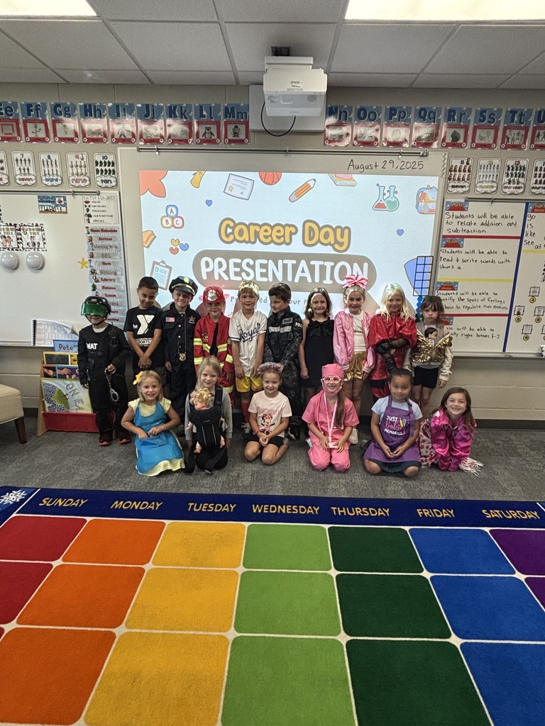 students smiling for a photo in a classroom