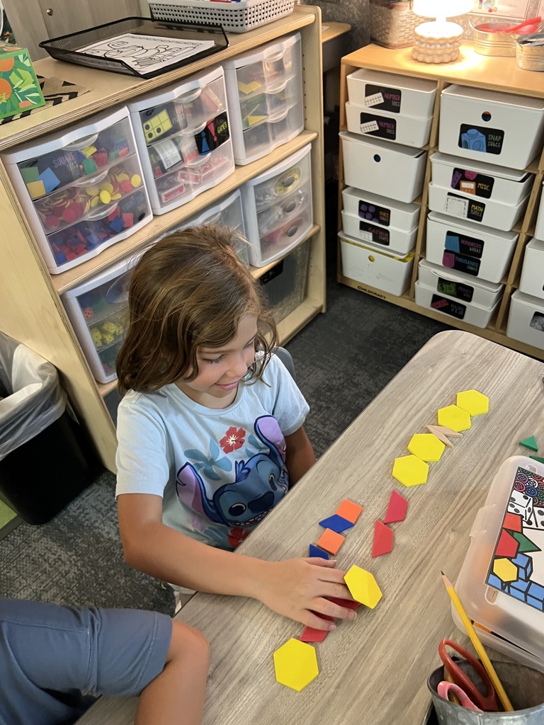 student smiling with patterns at desk