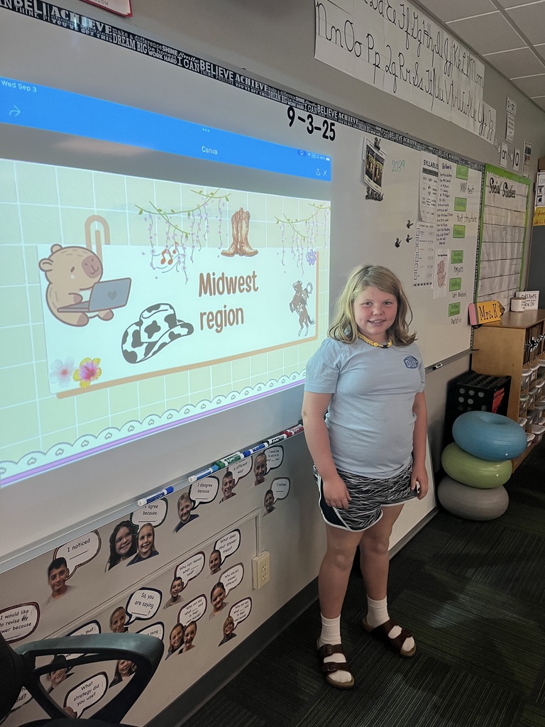 Girl standing in front of a whiteboard with  a presentation of the midwest region.