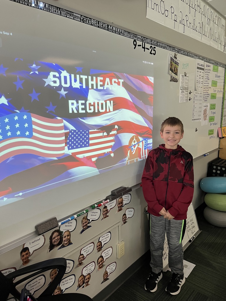 Boy standing in front of a whiteboard with a presentation of the southeast region.