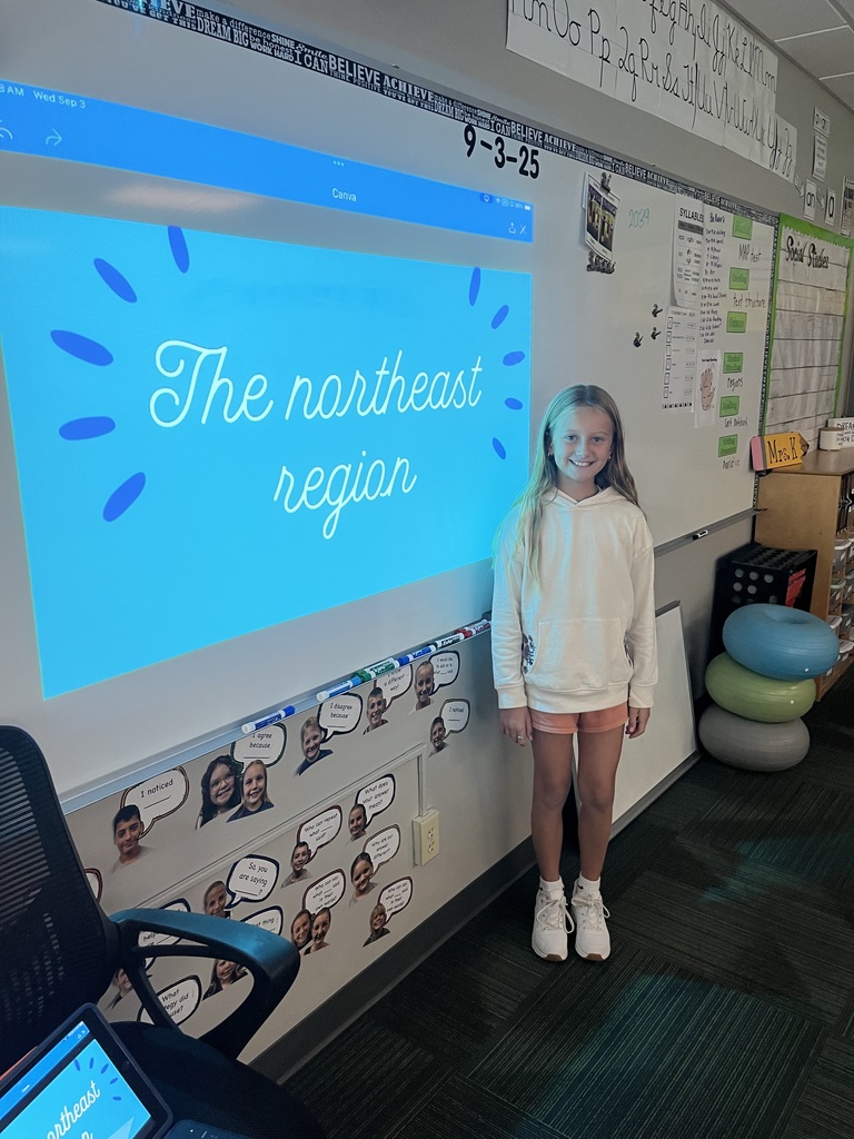 Girl standing in front of a whiteboard with a presentation of the Northeast region.