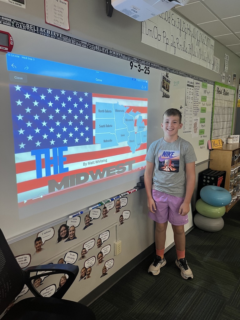 Boy standing in front of a whiteboard with a map of the midwest region.