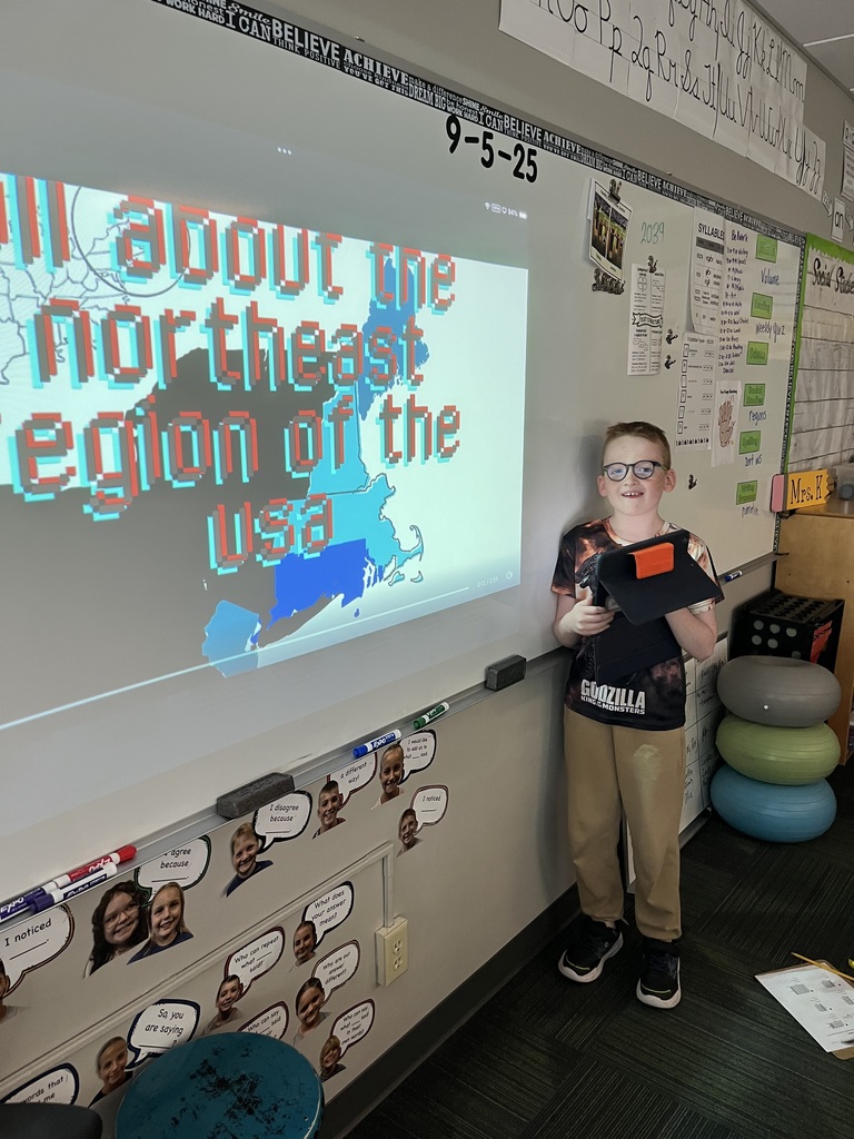 Boy standing in front of a whiteboard with a presentation of the northeast region.