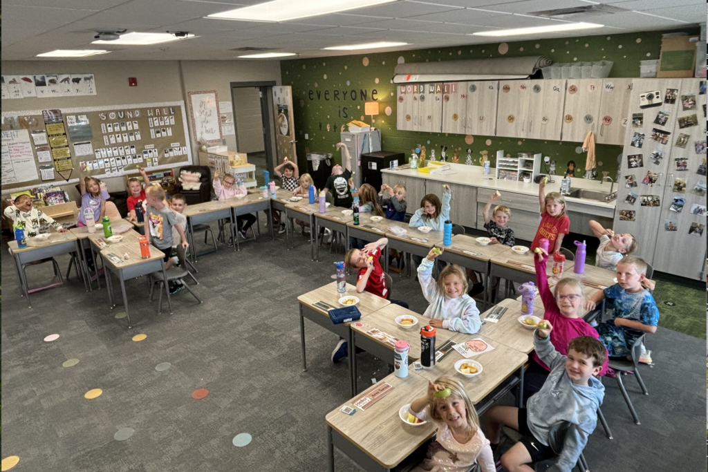 students tasting apples in their classroom