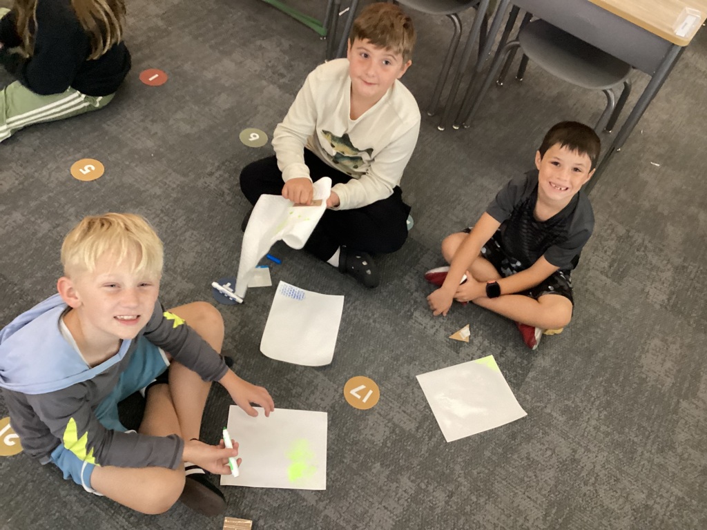  students working on art in a classroom