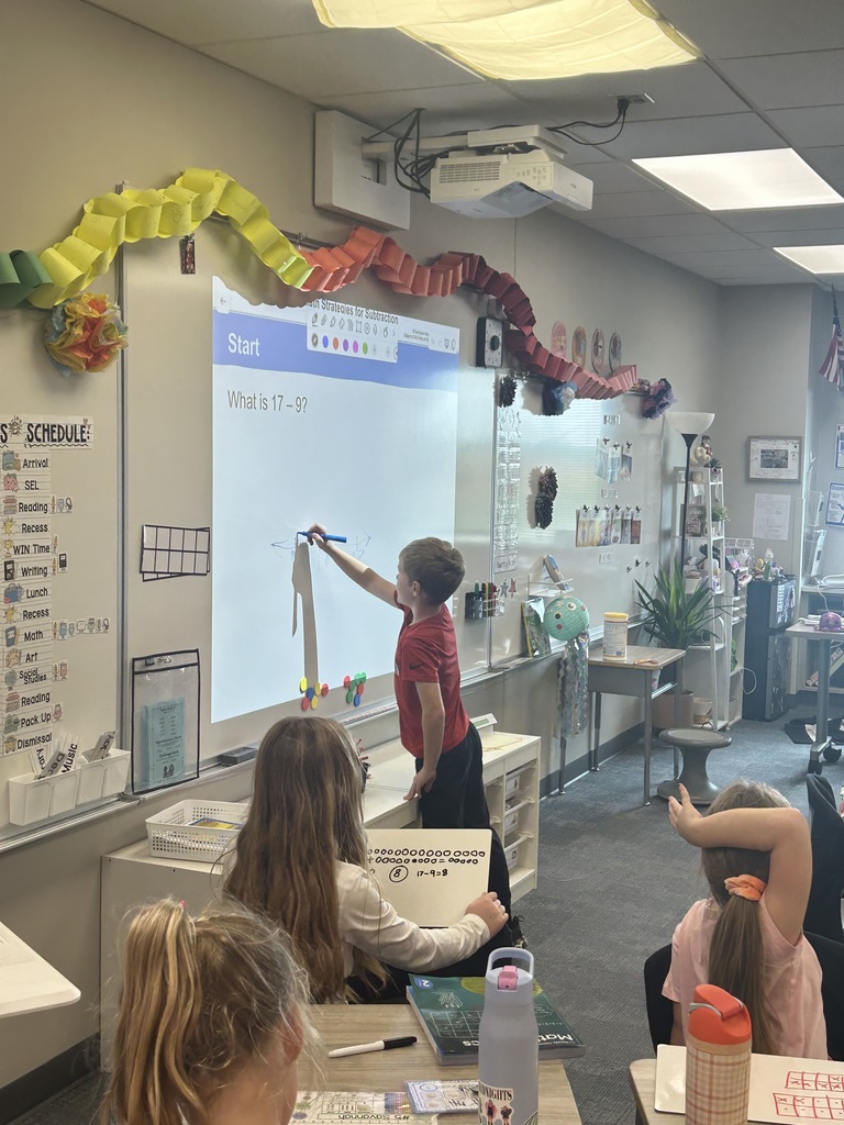 a student at the board showing math abilities