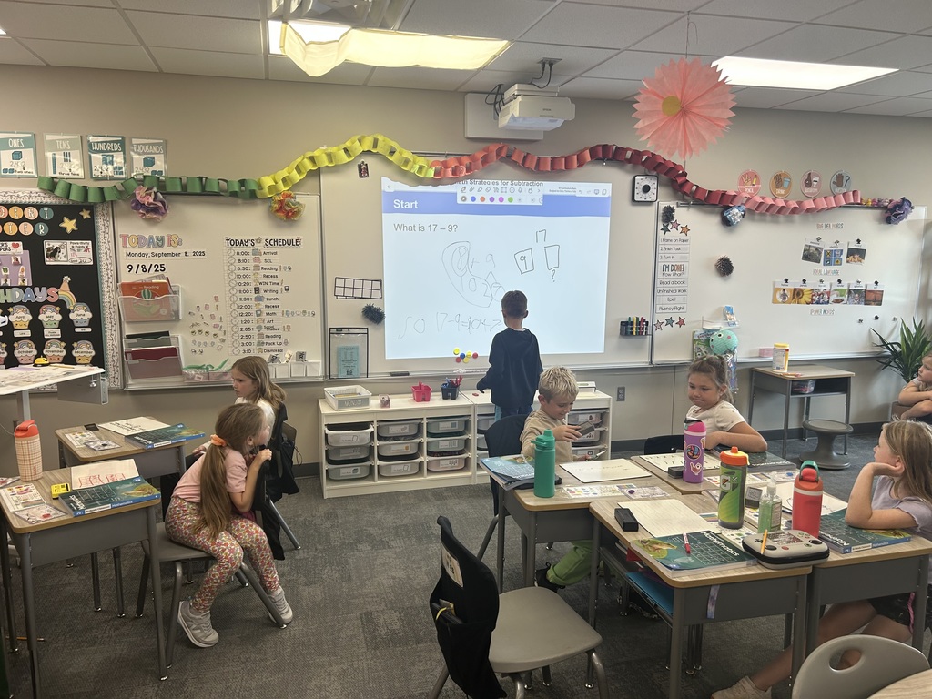 a student at the board showing math skills