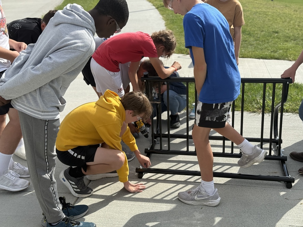 8th grade students attach the bike rack. 