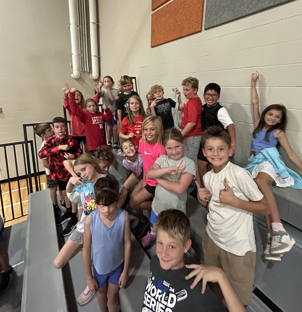 students on the bleachers in the gym