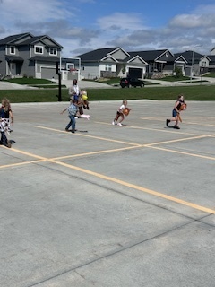  kids playing round up games outside