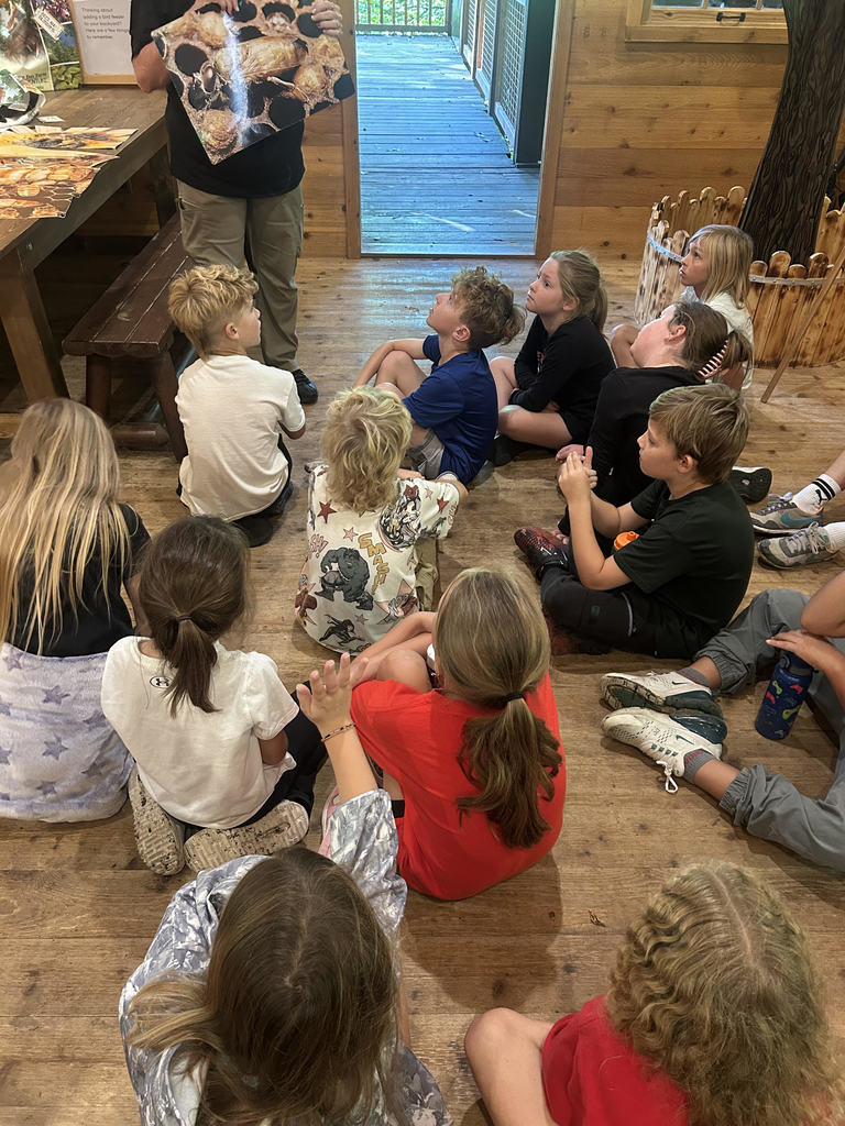 students sitting and learning on a field trip