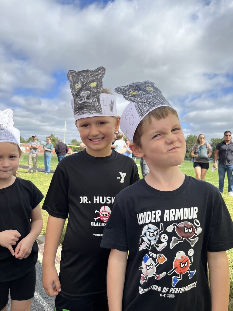 Students wearing black shirts with paper headbands showing black panthers.