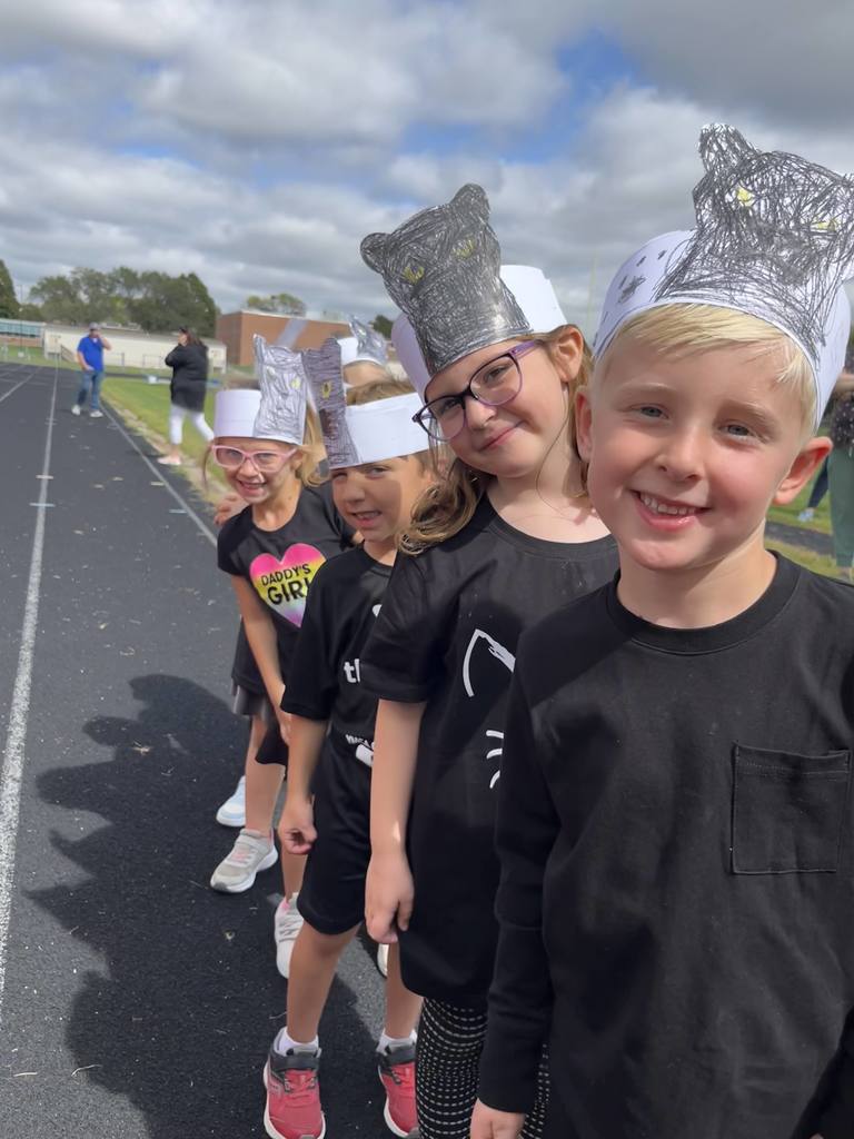 Students wearing black shirts with paper headbands showing black panthers.