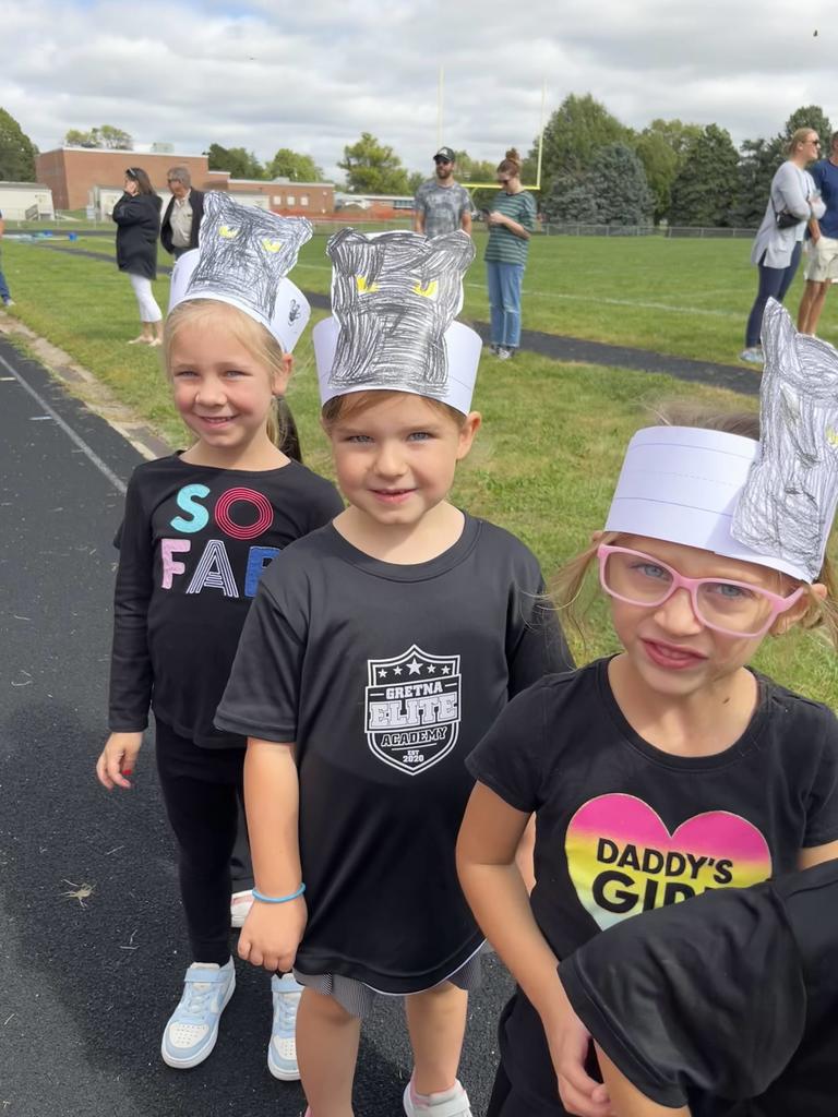 Students wearing black shirts with paper headbands showing black panthers.