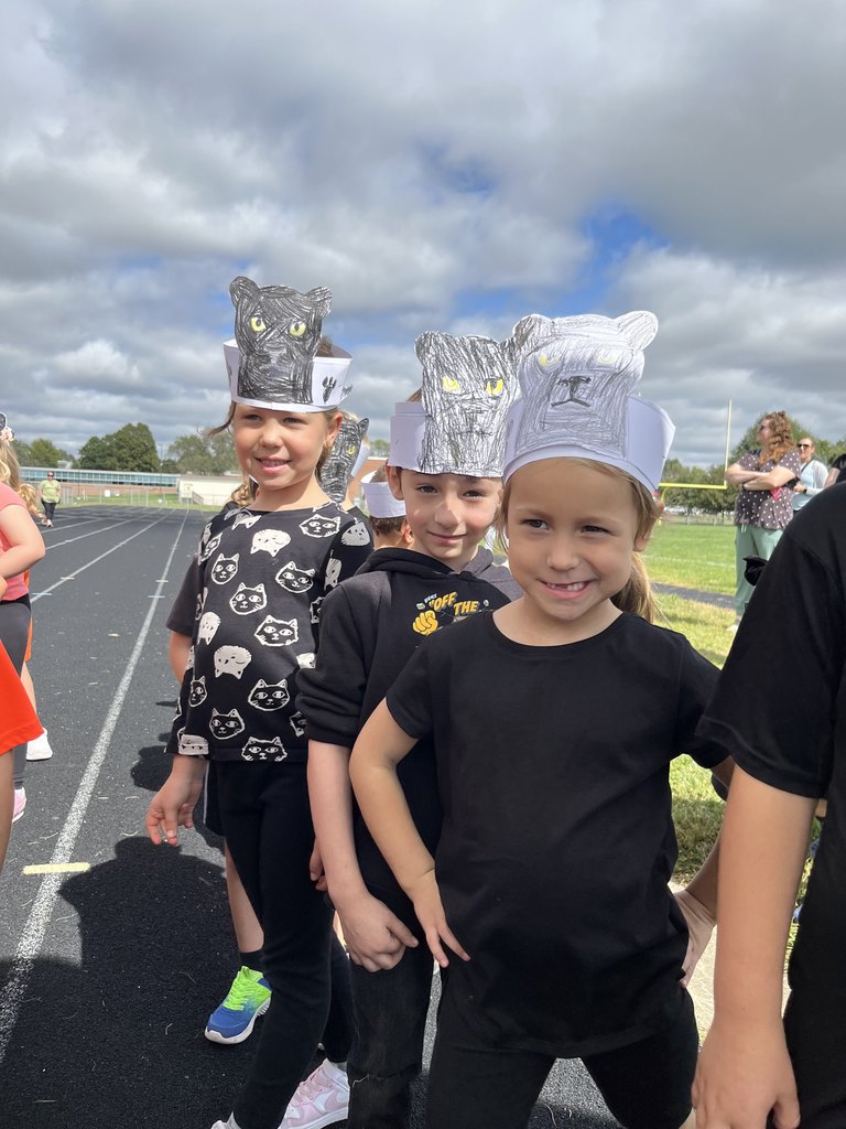 Students wearing black shirts with paper headbands showing black panthers.