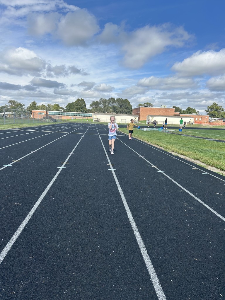 Girl and a boy running on a track.