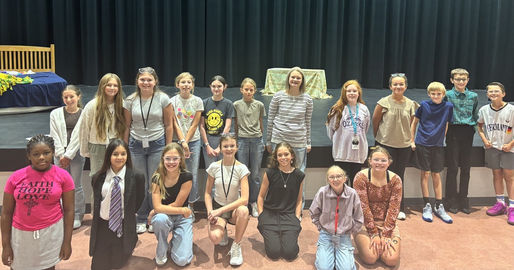 6th grade students who dressed up for sprit week, posing in front of the stage in the cafeteria. 
