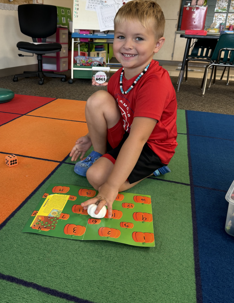 A student is using a pumpkin game to show his number recognition skills.