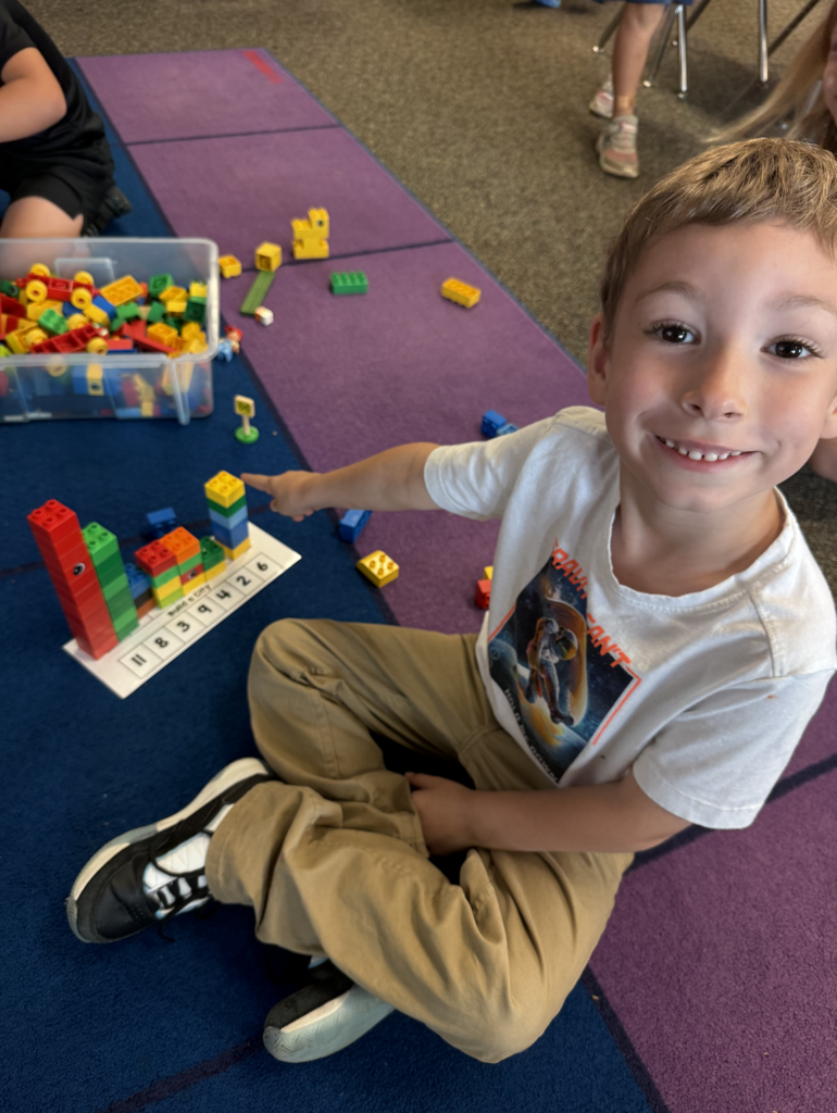 A student is using legos to show their number recognition and counting skills.