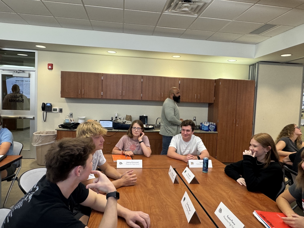 high school students at large tables together getting to know each other