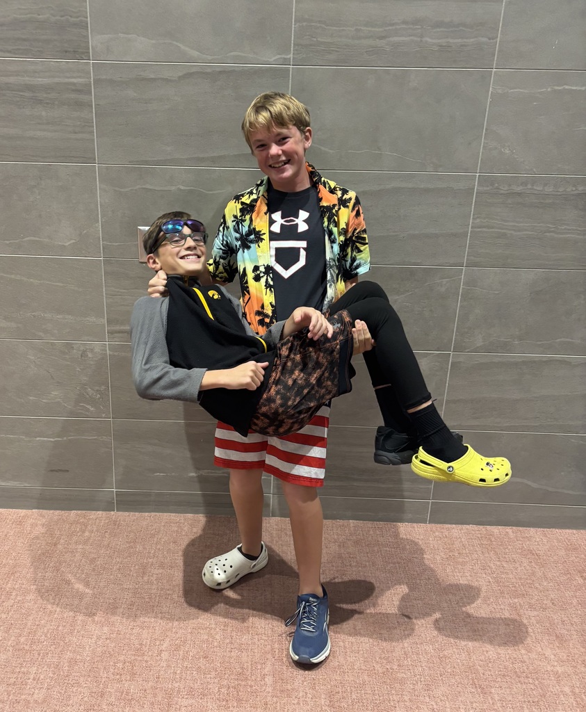 Students dressed "wacky" on Tuesday, including mismatched shoes and slippers. Here, one boy is carrying another in the cafeteria. 