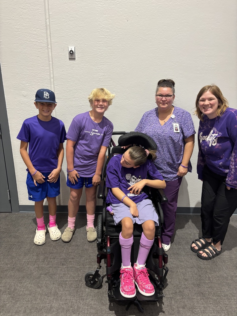 Staff and students wearing purple to support a classmate. 