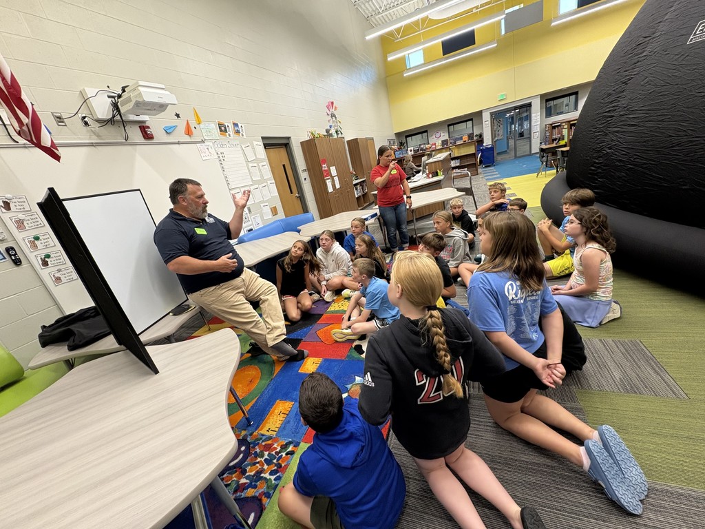 This is a picture of Ms. Ferzley's class listing to the speaker before entering the planetarium.