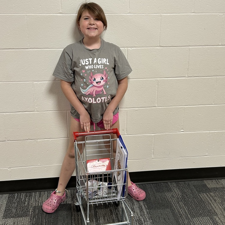 a student with a shopping cart for her “backpack”