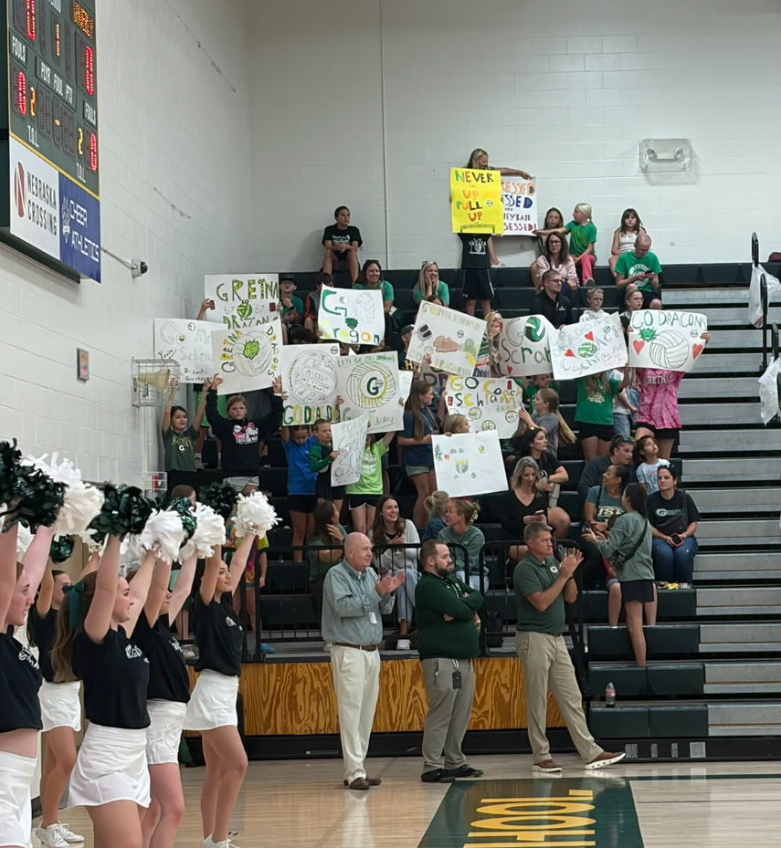 students cheering at a volleyball game