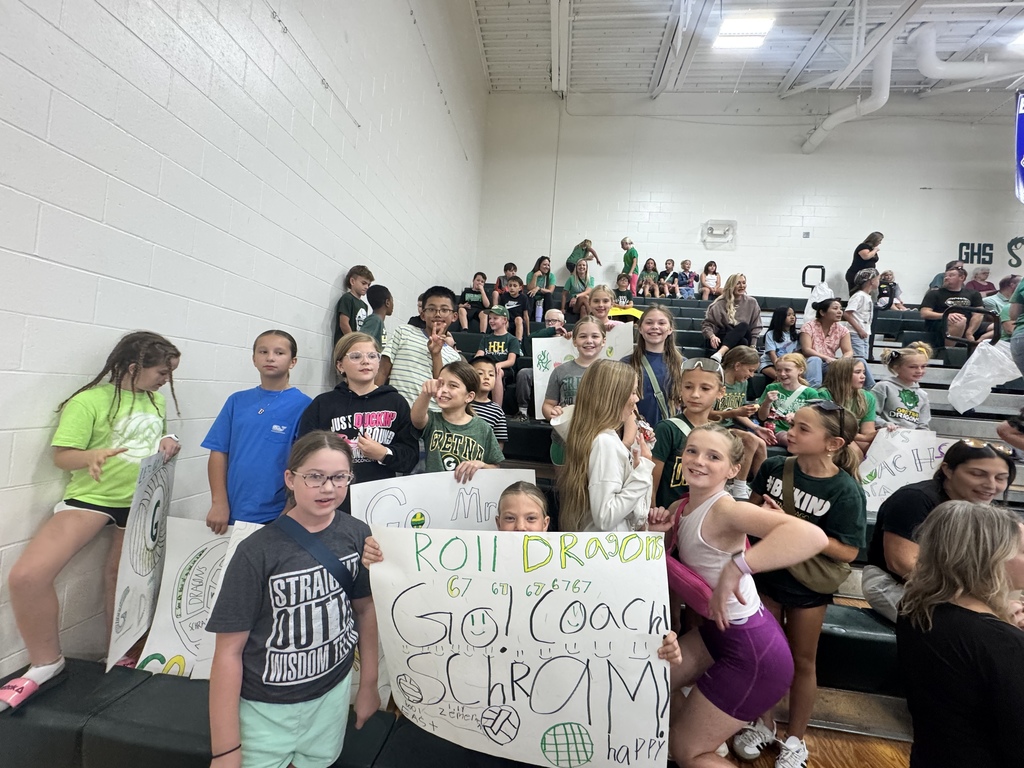 students cheering at a volleyball game