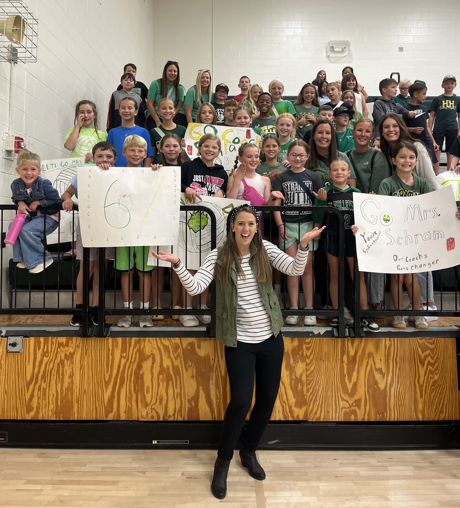 students cheering at a volleyball game