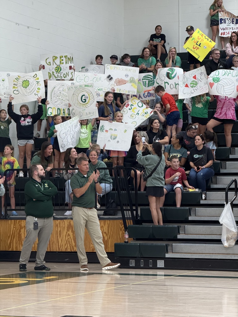 students cheering at a volleyball game