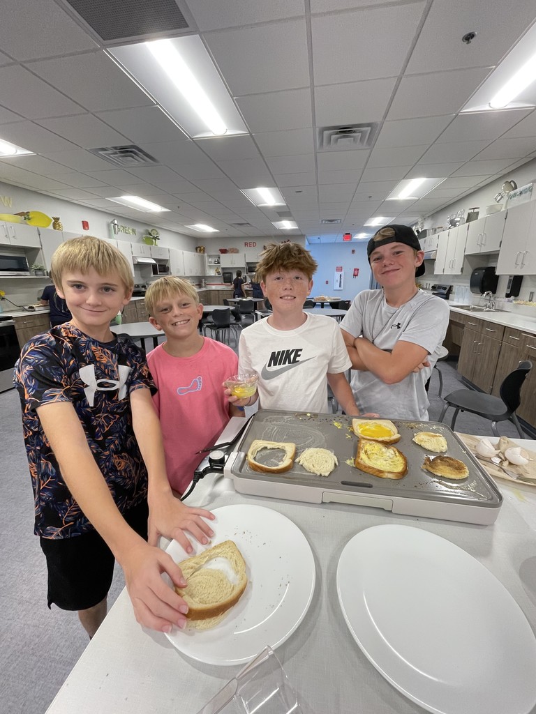 6th grade students showing their eggs in a frame.