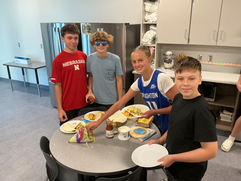 8th grade students preparing their tacos.