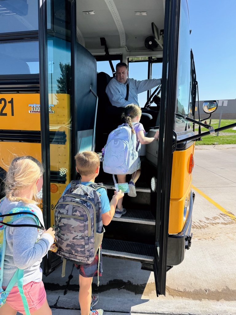 Students boarding the school bus on their way home with Superintendnet Lightle driving