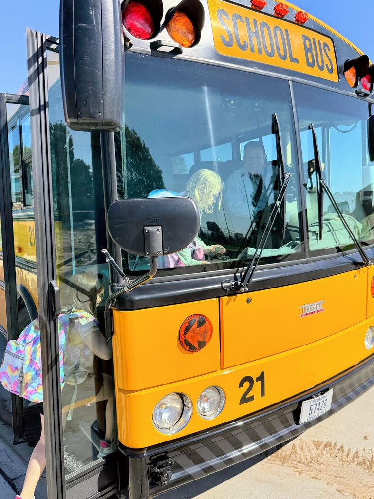 Students boarding the school bus on their way home with Superintendnet Lightle driving