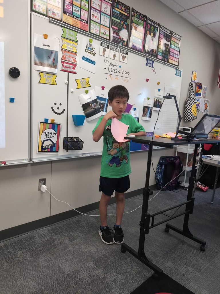 a student teaching origami in class