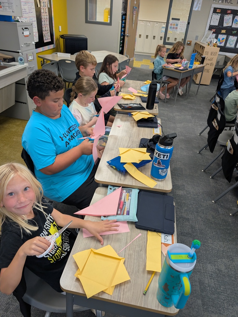 students working on origami in class