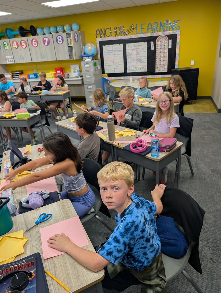 students doing origami in class