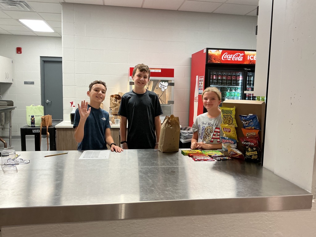 Photo of three students behind the counter in the concession stand.