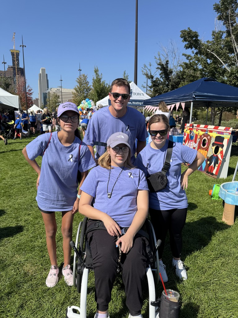 A photo of 3 students and 1 teacher supporting Down Syndrome Awareness walk