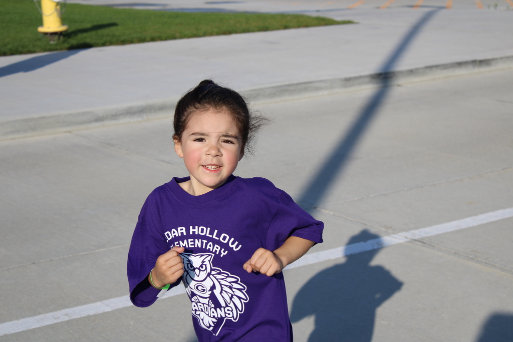 A kindergarten student races around the truck during the Hollow Hustle! 