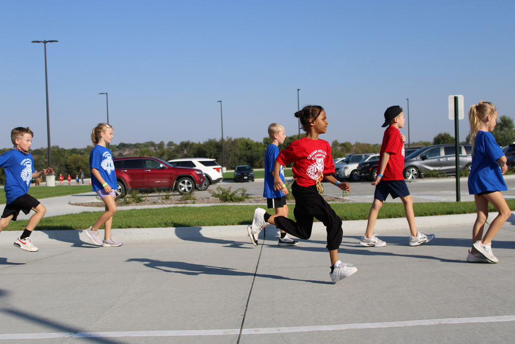 Second and third grade students walk or run to add more laps to their total. 