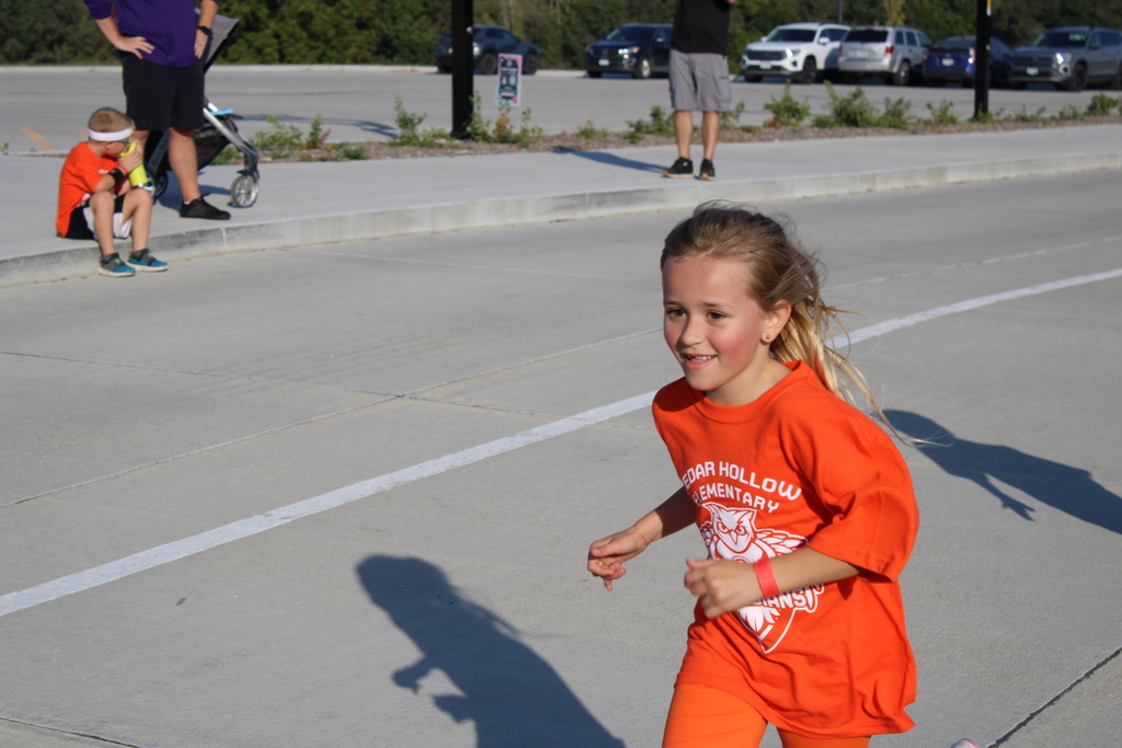 A first grade student adds another lap as she runs around the track. 