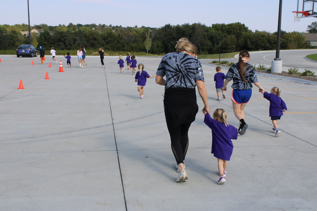 Ms. Mallory walks with her students as they begin to run their race! 