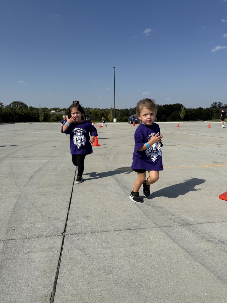 Preschool students run around the cones during their race!