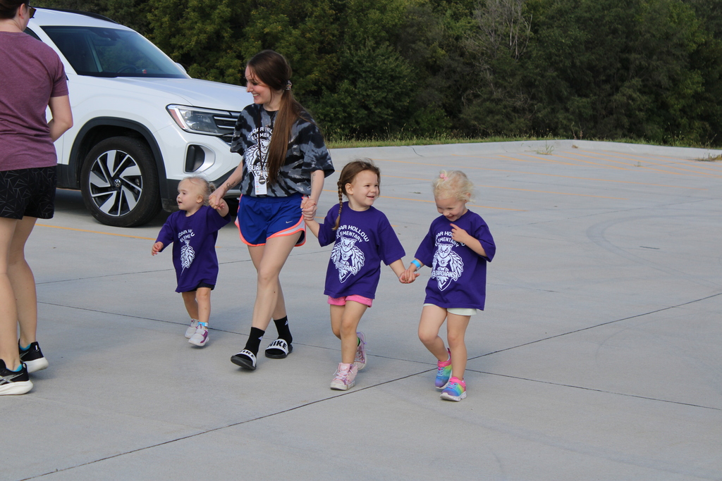 Students hold hands as they laugh and walk together during their Hollow Hustle.