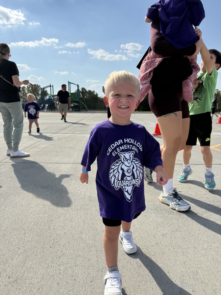 A preschool student shows his excitement for the hollow hustle race!