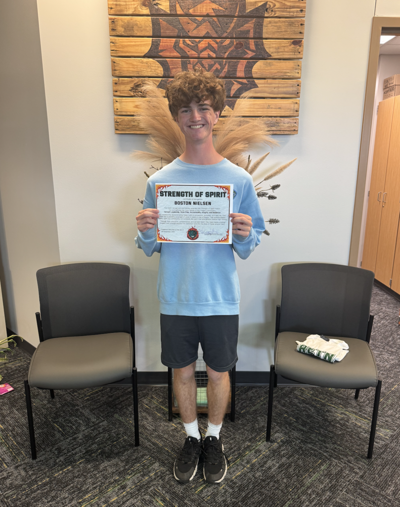 Boston Nielsen holding his certificate