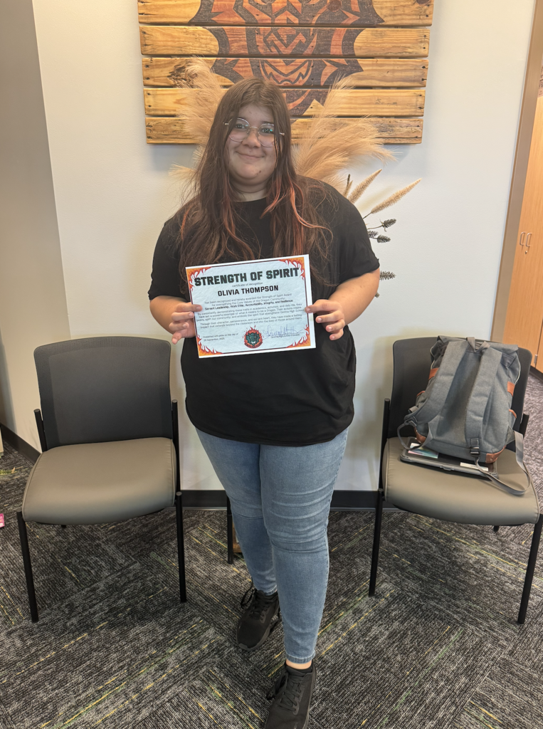 Olivia Thomsen holding her certificate 